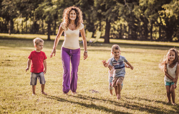 istock Happy kids jumping in nature 1181150189