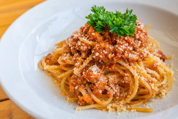istock Tasty minced beef spaghetti decorated with parsley and cheese 1181150247