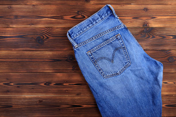 istock blue denim jeans  on wooden background - Image 1181150281