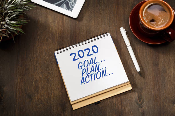 istock 2020 new year goal, plan, action text on notepad. Business motivation, inspiration concepts. Top view. 1181150862