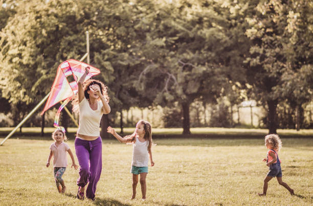 istock Kids running with kite in nature 1181150944