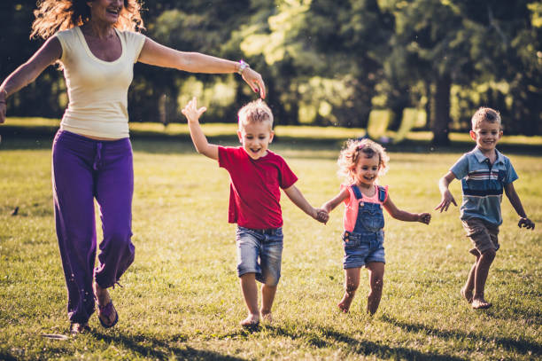 istock Group of happy children having fun while running in nature 1181151200
