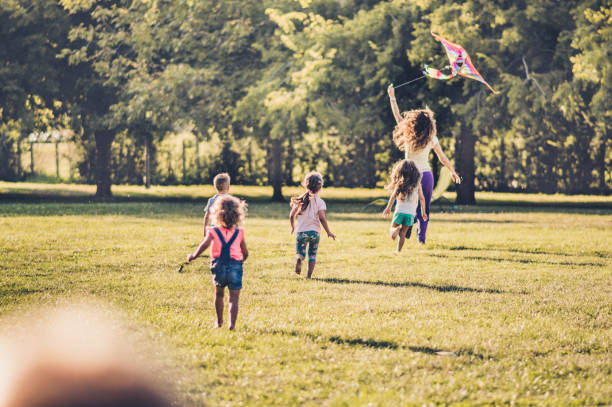 istock Kids running with kite in nature 1181151334