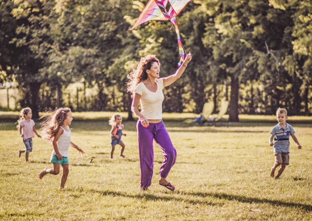 istock Kids running with kite in nature 1181151430