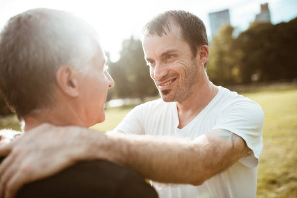 istock gay couple bonding in central park 1181152575