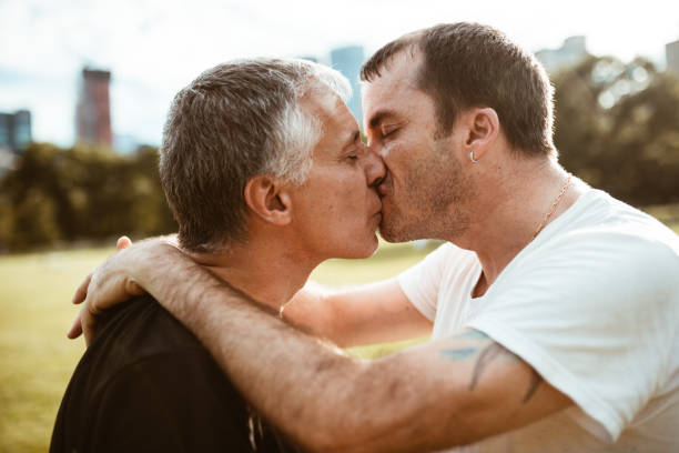 istock gay couple flirting on central park 1181152780