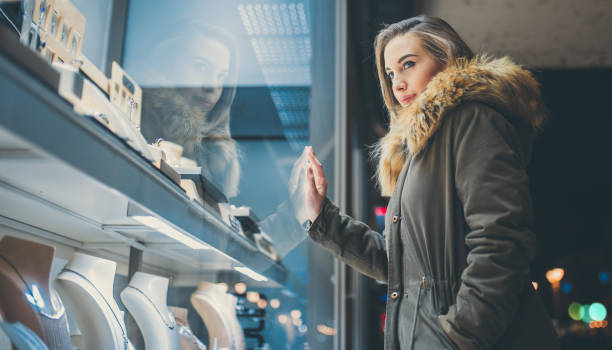 istock Woman window shopping at night 1181152797
