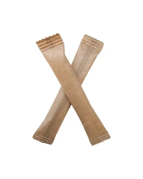 Photo of Paper brown sticks laid out in the shape of the letter X.