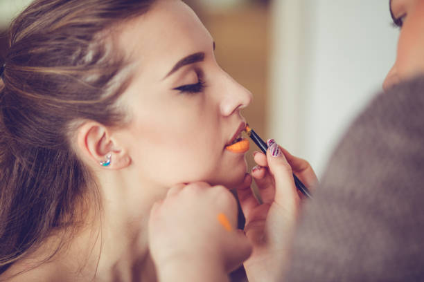 Young caucasian woman getting fluorescent makeup on.
