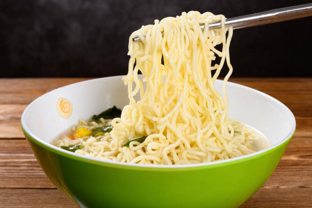 istock chopsticks picking up instant noodles with sauce 1181155219