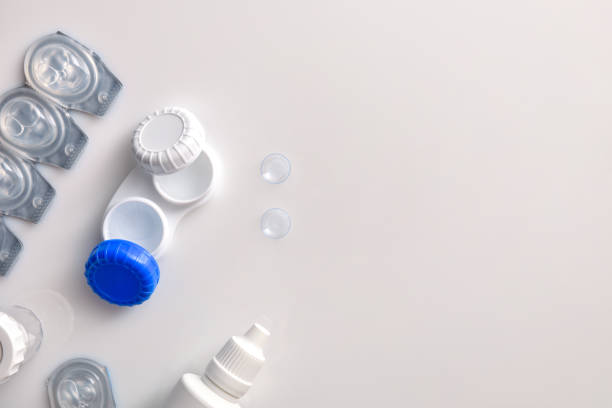 istock Contact lenses containers and solutions on white table top 1181156827
