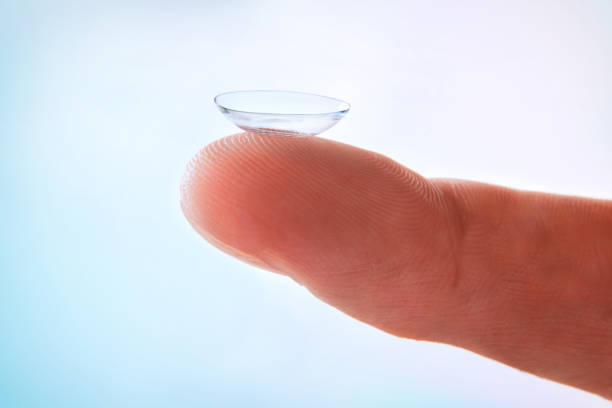 istock Finger detail with contact lens with blue gradient background isolated 1181156842