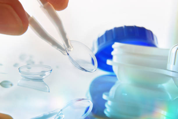 istock Manipulating a lens reflected on a glass table bluish 1181156860
