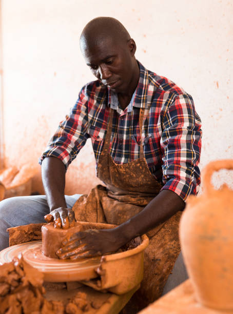 istock Craftsman woring with clay on potter wheel 1181157645