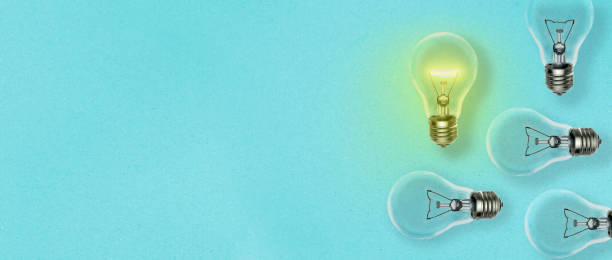 istock Idea concept background with many light bulbs dropping shadow on a blue paper sheet and copy space for your text 1181158026