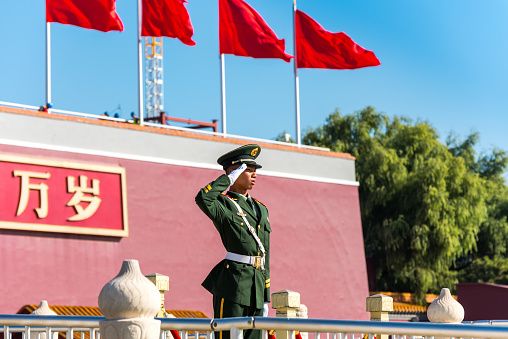Security guard standing in front of the Tiananmen Gate, at the entrance of the Forbidden City in Beijing, China.