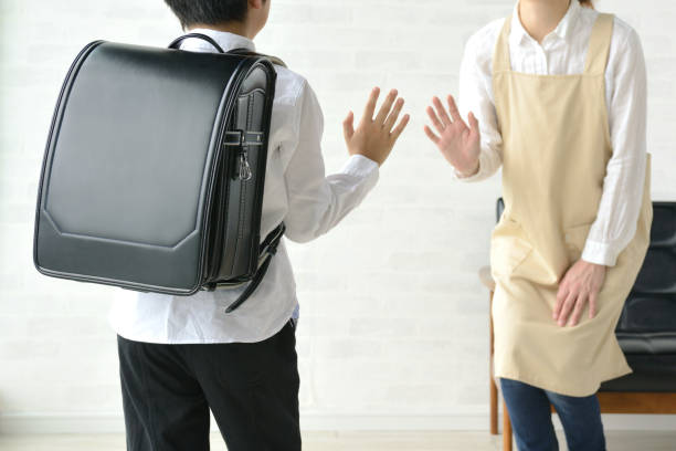 Boy going to school and mother seeing off Boy going to school and mother seeing off randoseru stock pictures, royalty-free photos & images