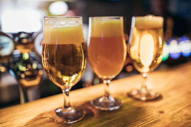 Glass with beer on bar counter in pub, no people.