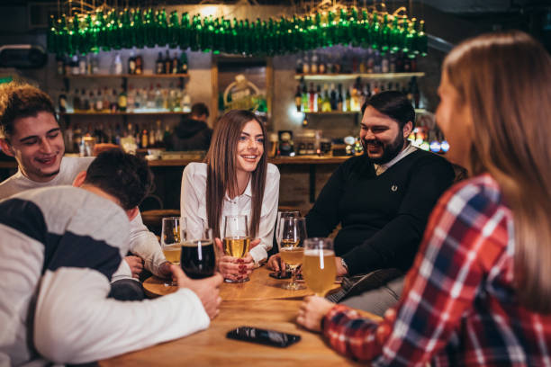 istock Group of friends sitting in pub 1181163493