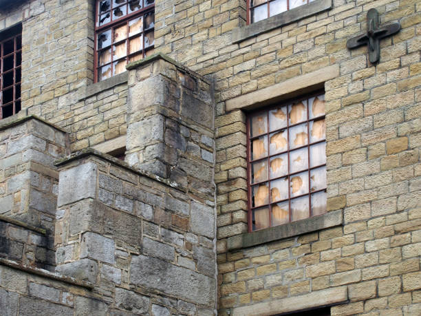 an old abandoned factory building with boarded up and broken windows