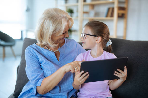 istock Grandma and granddaughter with digital tablet 1181170459