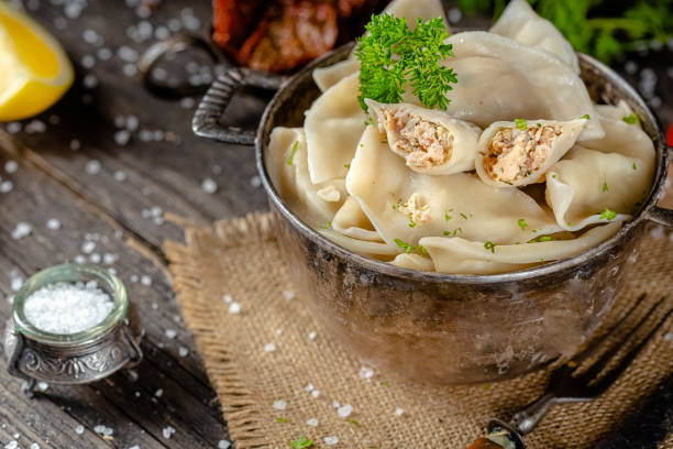 dumplings made of red and white fish meat, in a vintage rustic bowl plate, fork knife spoon, salt, spices, fresh herbs, stand and lie, different angles, on a wooden cutting kitchen table, dark light albóndigas hechas de carne de pescado rojo y blanco, en un plato de cuenco rústico vintage, cuchara de cuchillo de tenedor, sal, especias, hierbas frescas, soporte y mentira, diferentes ángulos, en una mesa de cocina de corte de madera, luz oscura