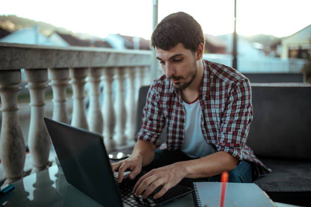 istock Young man sitting in coffee shop and using laptop 1181170744