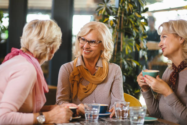 istock Three senior ladies socializing over coffee in cafe 1181170805
