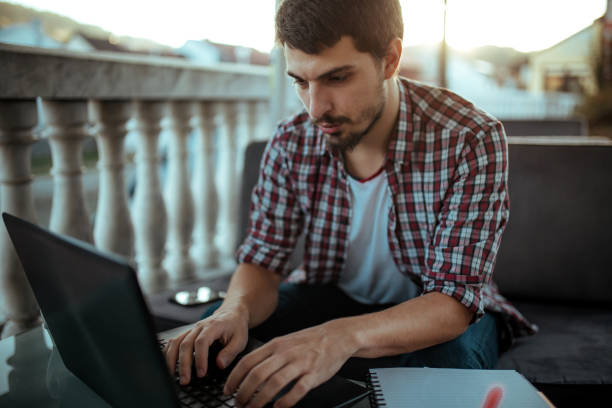 istock Young man sitting in coffee shop and using laptop 1181170875