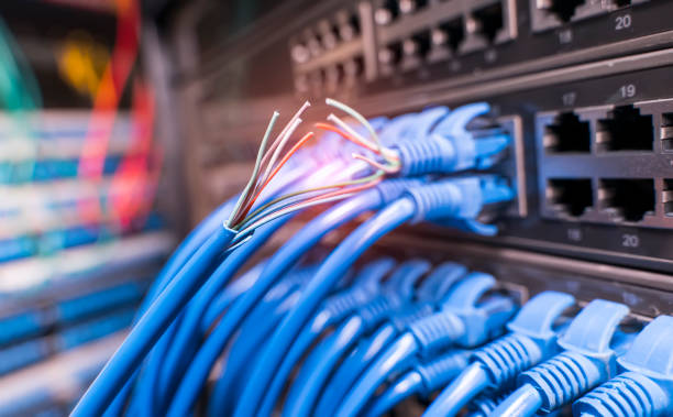 istock Damaged stranded network cable is located on the background of the server room. Problem with communication 1181171111