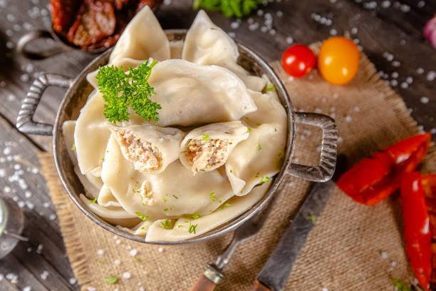 dumplings made of red and white fish meat, in a vintage rustic bowl plate, fork knife spoon, salt, spices, fresh herbs, stand and lie, different angles, on a wooden cutting kitchen table, dark light albóndigas hechas de carne de pescado rojo y blanco, en un plato de cuenco rústico vintage, cuchara de cuchillo de tenedor, sal, especias, hierbas frescas, soporte y mentira, diferentes ángulos, en una mesa de cocina de corte de madera, luz oscura