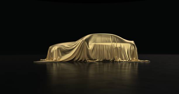 The luxury car is covered with a gold cloth on a black background. The luxury car is covered with a gold cloth on a black background. car show photos stock pictures, royalty-free photos & images