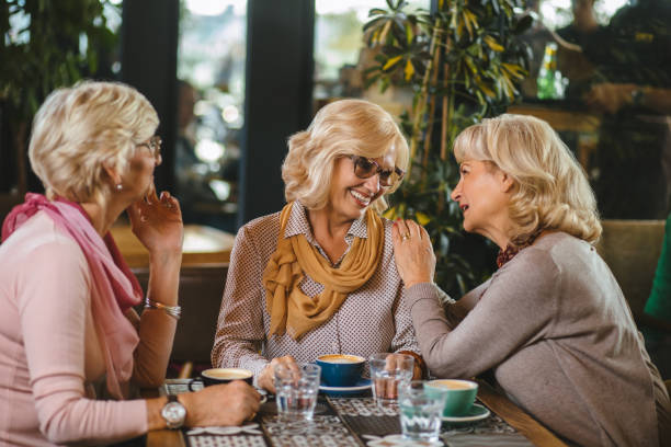 istock Three senior ladies socializing over coffee in cafe 1181172293