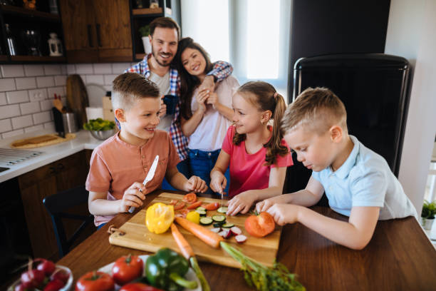 istock Children preparing vegetable salad in the kitchen 1181172452