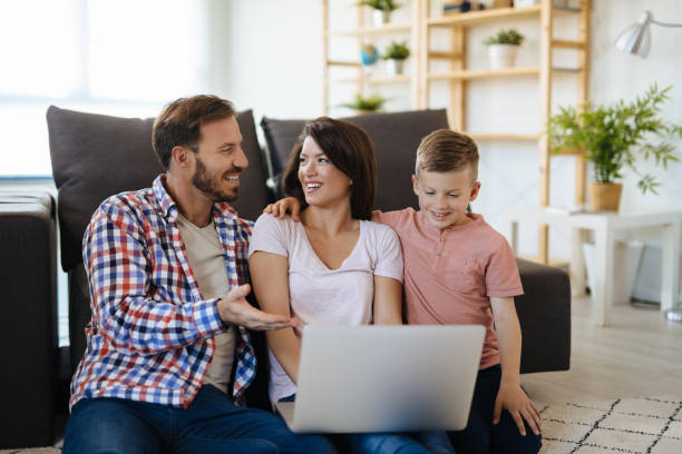 istock Happy family with little boy enjoying using laptop computer 1181172589