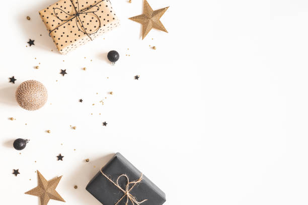 istock Christmas composition. Gift box, beige and black decorations on white background. Christmas, winter, new year concept. Flat lay, top view, copy space 1181173430