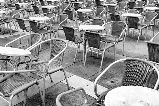 External seating at a restaurant in San Marco Square in Venice. In the foreground are the tables and chairs still unoccupied as it is early in the morning.