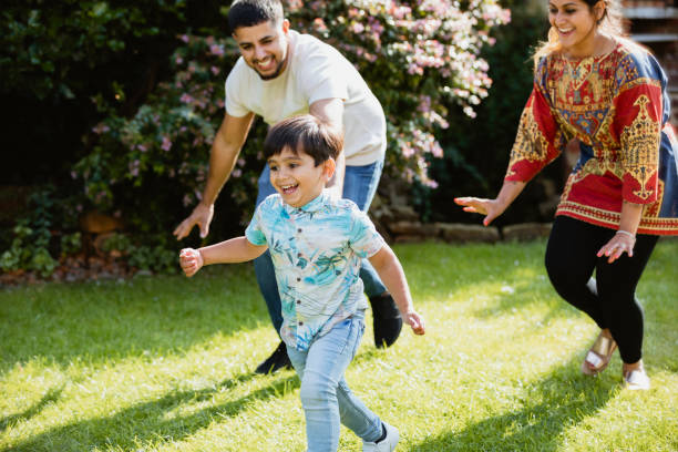 istock Family Chasing In Garden 1181193786