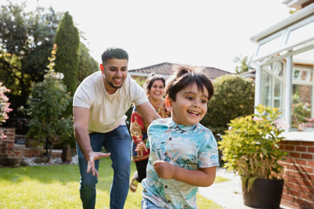 istock Family Chasing In Garden 1181193865