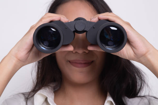 istock Young Asian woman with binoculars. 1181194146