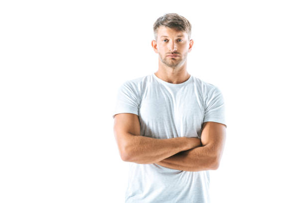 istock handsome man looking at camera and standing with crossed arms isolated on white 1181196325