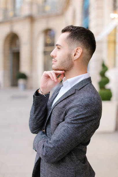 istock Young caucasian man wearing grey suit standing near building 1181197313