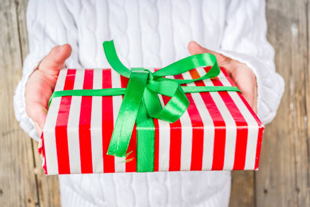 istock Girl hands Hold Christmas Gift 1181197341