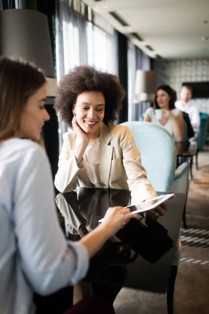 istock Happy friends having a good conversation sitting in a restaurant 1181197659