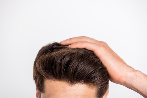 Cropped close-up photo of macho fix his haircut after anti dandruff therapy, isolated over white background