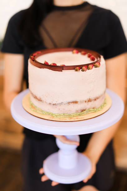 istock Woman keeping birthday cake with copy space 1181204970