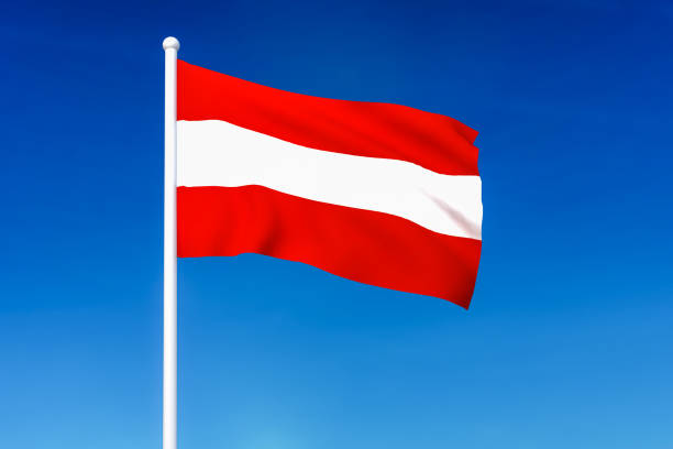 istock Waving flag of Austria on the blue sky background 1181205960