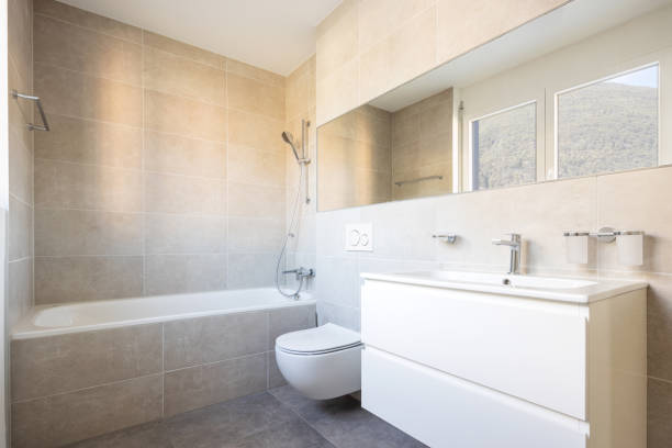 istock Modern minimal bathroom with large tile bathtub 1181206685