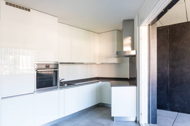 istock Modern white kitchen in empty apartment with white walls 1181206712