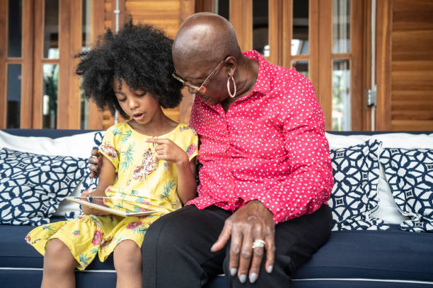 istock Granddaughter and grandmother using digital tablet 1181207404